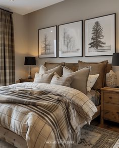 a large bed sitting in a bedroom next to two framed pictures