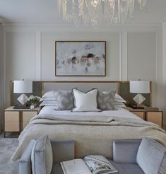 a large bed sitting in a bedroom under a chandelier