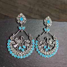 Fun & Flirty chand balis with nature inspired details that compliments your kalamkari, fusion, casual outfits Color: Turquoise Length: 3 Inches Width: 2.75 Inches Bohemian Drop Earrings For Festive Bridal Wear, Turquoise Earrings For Festive Occasions, Festive Turquoise Earrings As Gift, Festive Turquoise Earrings For Gift, Festive Bohemian Drop Bridal Earrings, Bohemian Silver Chandbalis With Matching Earrings, Bohemian Metal Earrings With Peacock Design, Bohemian Earrings With Oxidized Finish For Parties, Bohemian Drop Earrings For Festive Season