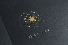 a black book with gold lettering and a starburst on the cover that says galaxy