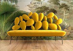 a yellow couch sitting on top of a wooden floor in front of a wall mural