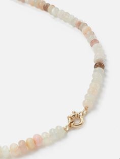 The Encirkled Cashmere Ombre Gemstone Necklace is perfect for everyday and includes a 14k yellow gold spring ring clasp that is perfect for holding your favorite charms. Assorted 8mm gemstones that may include agate, aventurine, chocolate moonstone, peach moonstone, Peruvian opal, rainbow moonstone, rutilated quartz, rose quartz, selenite, and strawberry quartz Gemstone card comes with each necklace with list of included gemstones 12mm 14k yellow gold spring ring clasp Each piece is unique and m Yellow Gold Beaded Necklaces With Natural Stones, Moonstone Gemstone Beads Jewelry For Healing, Elegant Pink Opal Round Necklace, Moonstone Jewelry With Natural Round Beads, Moonstone Jewelry With Round Natural Stones, Pink Opal Gemstone Necklace, Elegant Pink Opal Gemstone Necklace, Rondelle Agate Jewelry With Natural Stones, Faceted Moonstone Round Bead Necklaces