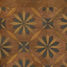 an old wooden table with many different designs on it's woodgrain and paint