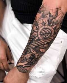 a man with a black and grey tattoo on his arm