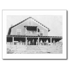 an old black and white photo of people standing in front of a large house with porches