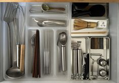 an organized drawer with utensils and spoons