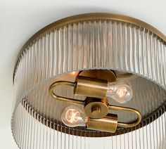 a light fixture with three lights on it's side and two bulbs in the middle