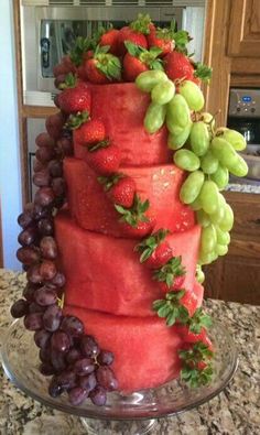 a cake made out of watermelon, grapes and strawberries