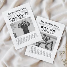 two newspaper articles laying on top of a bed next to a bouquet of baby's breath flowers