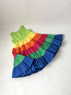 ✿ABOUT THIS DRESS ✓Our handmade sleeveless design is perfect for warmer weather, and the twirly skirt adds a playful touch that little girls will love.  ✓The rainbow colors are eye-catching and fun, making this dress perfect for parties, playdates, or just a day out with the family. ✓The dress is made from high-quality terry cotton fabric and is designed to be comfortable and durable. It is also easy to care for, making it a practical choice for parents. ✿FABRIC INFORMATION ✓Terry cotton fabric. Pretty Dresses For Kids, Twirly Skirt, Kids Frocks Design, Sewing Kids Clothes, Full Circle Skirt, Girl Rainbow, Kids Frocks, Rainbow Dress, Easter Girl