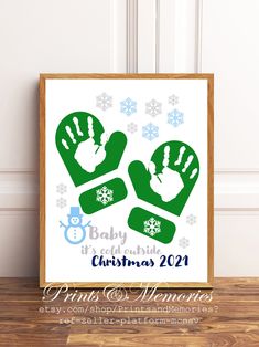 a baby's first christmas card with two hands and snowflakes on it