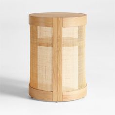 a round wooden table with woven material on the top and bottom, against a white background