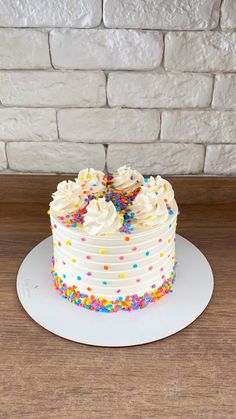 a cake with white frosting and sprinkles