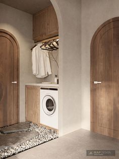 a washer and dryer in a room with wooden doors