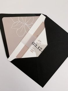 a black envelope with a white flower on it