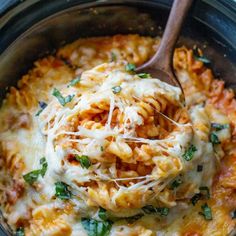 a crock pot filled with pasta and cheese