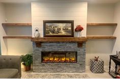 a living room with a fire place in the center and shelves on either side of the fireplace