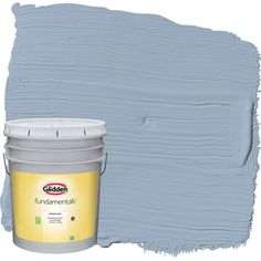 a paint can with a white bucket next to it on a white background that has been painted in shades of blue and yellow