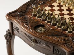 a wooden chess set with gold and silver pieces on it's board, sitting on a table