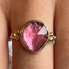 This freeform pink tourmaline is set in 14k yellow gold with gold accent beads, brilliant white diamonds and Emily's signature gold band. Approximate stone size: 12mm x 10mm Mohs Hardness: 7-7.5 Each piece is handmade with love in our Hudson Valley studio. This ring is one of a kind and currently ready to ship at size 7.5. Free resizing is available prior to shipping. Gold Tourmaline Rings, Pink Tourmaline Jewelry With Accent Stones, Pink Gold Tourmaline Jewelry With Gemstones, Rose Gold Tourmaline Jewelry With Accent Stones, Pink Tourmaline Jewelry With Gemstone Accents, Yellow Gold Tourmaline Gemstones With Accents, Gold Tourmaline Rings With Gemstone Accents, Gold Rings With Tourmaline Gemstone Accents, Wall To Wall Carpet