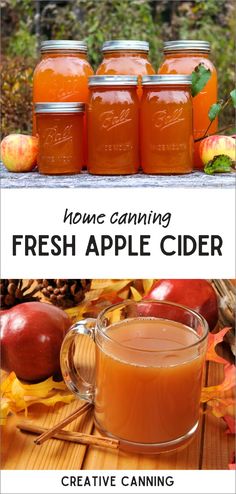 four jars filled with fresh apple cider sitting on top of a wooden table next to apples