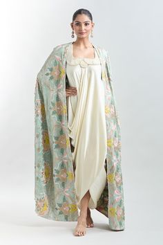 Wash blue longline cape with tonal and pastel multi colored embroidery. Comes with pearl embroidered yoke white draped slip dress. - Aza Fashions Anamika Khanna Cape, Square Dress, Embroidered Floral Dress, Embroidered Cape, Anamika Khanna, White Drapes, Blue Floral Dress, Floral Embroidered Dress, Draped Dress