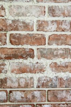 an old brick wall with white paint