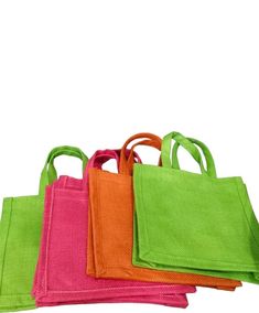 four different colored bags sitting on top of each other in front of a white background