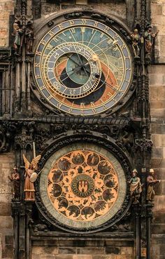 an ornate clock with roman numerals on the side of a building in europe