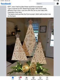 three wooden christmas trees on top of a table