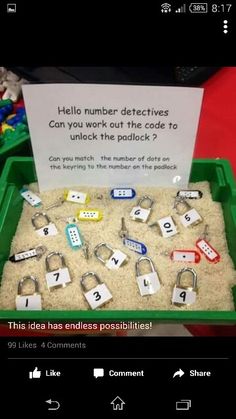 a green tray filled with lots of sand and magnets next to a sign that says keys and locks with numbers on them