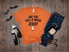 Celebrate the fall season with a touch of faith and humor in this Christian Halloween shirt! Featuring the playful phrase "Are You Fall-O-Ween Jesus?" with a cute pumpkin design, this tee is perfect for adding a lighthearted and inspirational twist to your autumn wardrobe. 🎃✝️ Whether you're at church events, fall gatherings, or just enjoying the season, this shirt is a great way to share your faith with a smile. Soft, high-quality fabric for all-day comfort Fun and inspirational Christian design for the fall season Available in various sizes for men, women, and teens Ideal for church events, fall activities, or casual wear A perfect gift for those who love faith-based humor and fall fashion 𝗛𝗢𝗪 𝗧𝗢 𝗢𝗥𝗗𝗘𝗥 𝟏. Please, Check and Review all Listing Photos. 𝟐. Select Your T-Shirt Si Christian Halloween, Fall O, Jesus Tees, Funny Pumpkins, Autumn Wardrobe, Church Events, Christian Designs, Fall Activities, Christian Shirt