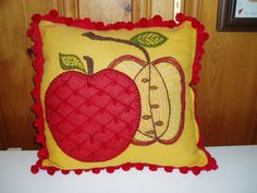 a decorative pillow with an apple on it