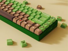 a computer keyboard with green keys and some dice on the ground next to it,