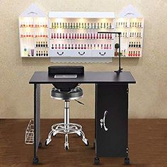 a computer desk sitting on top of a wooden floor next to a shelf filled with bottles