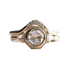 a gold and white diamond ring on a white background