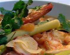 a bowl filled with shrimp, celery and carrots