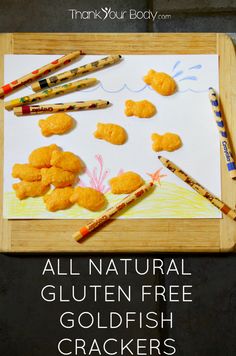 an image of some food on a cutting board with crayons and pencils