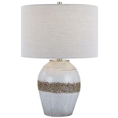 a white and gold table lamp with a beige shade