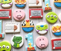 decorated cookies are arranged in the shape of children's birthday items, including toys and books