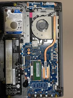 the inside of a laptop with its motherboard and hard drive removed from it's side