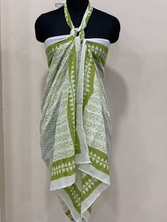 "Colorful, woodblock printed, cotton sarong, perfect for a day by the shore or to lounge in comfort at home. Wrap it in a variety of ways, as a beach dress (see photo), or around the waist, or simply use it to lie on at the beach. A versatile addition to any wardrobe! Measures 44\" x 72\"(180cm x110cm ) *Made of 100% cotton. *Hand Block printed *Machine wash on warm/cold *Production Capacity: 1000 Naturally occurring dye variations are found on all hand printed textiles, making each piece unique Patterned Batik Print Sarong For The Beach, Bohemian Sarong With Traditional Patterns For Beach, Green Bohemian Batik Print Dupatta, Green Batik Print Sarong For Beach, Green Cotton Sarong For Vacation, Traditional Summer Sarong With Block Print, Traditional Block Print Sarong For Summer, Traditional White Cotton Sarong, White Printed Cotton Sarong