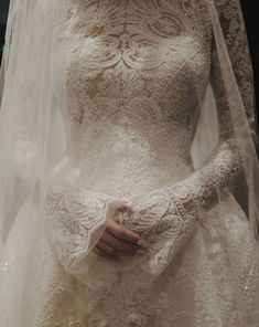 a woman wearing a wedding dress and veil