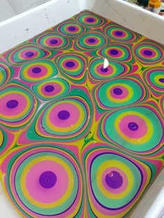 a table that has been painted with different colors and shapes in the shape of circles