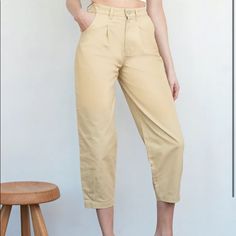 On Days When Skinny Jeans Just Won't Do, Look No Further Than These Smart-Looking Pants. Pleats At The Front And Darted Cuffs Lend A Touch Of Sophistication To Their Easy Silhouette. - High Rise - Pleated Front - Relaxed Fit - Cropped - Darted Hems - Zip Fly With Button Closure Spring Cargo Pants With Tapered Leg, Spring High-waisted Chinos, High Waist Cotton Dress Pants For Spring, Spring High Waist Cotton Dress Pants, Solid Work Pants With Loosely Fitted Hips For Spring, Non-stretch High Waist Cotton Dress Pants, Spring Khaki High-waisted Work Pants, Spring Non-stretch High-waisted Work Pants, Non-stretch Tapered Leg Beige Pants