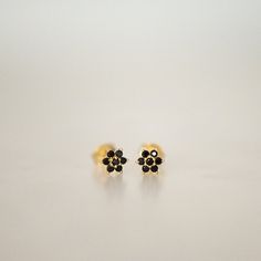 Dainty flower shaped stud earrings. Perfect for pairing with multiple piercings. Available in Black or Black with White CZ Stone DETAILS * Thick plating of 14k Gold or Rhodium over 925 Sterling Silver * Sold as a Pair * Hypoallergenic and nickel-free * 5 mm x 5 mm * Also available in white cz, ruby, sapphire or emerald Huggies on Model: https://www.etsy.com/listing/708078947/sapphire-huggie-earrings-gold-cz-huggies?ga_search_query=black%2Bhuggies&ref=shop_items_search_1&pro=1 Made with 1 Black Flower Drop Earrings For Gift, Dainty Black Pierced Earrings, Black Flower Shaped Earrings For Gift, Black Flower Earrings As Gift, Black Flower-shaped Earrings For Gift, Black Dainty Earrings, Small Earrings Gold, Stud Earrings Black, Black Stone Earrings