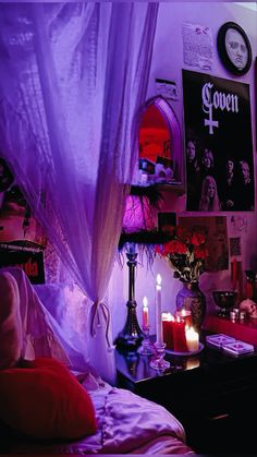 a bedroom with candles and pictures on the wall