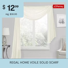 a white chair sitting in front of a window next to a light blue wall with the words regal home voile sold scarf