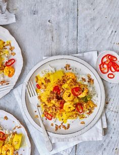 two white plates with food on them next to a fork