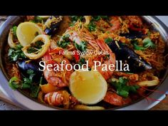 seafood paella with lemon wedges and parsley